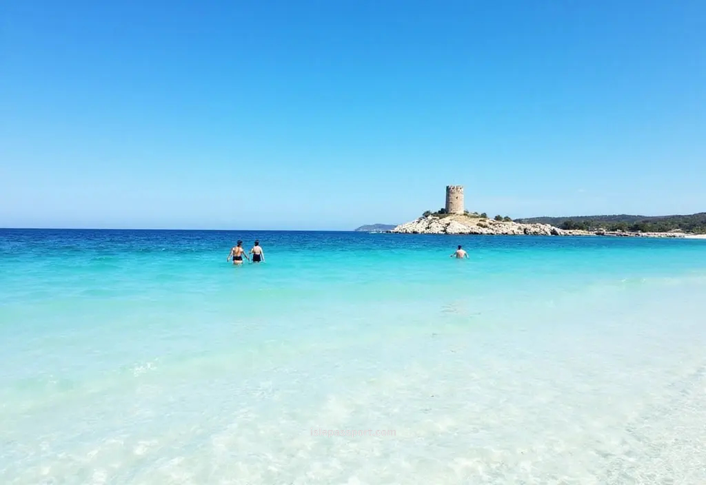 Traveler-phone view of shallow turquoise water at Spiaggia della Pelosa in Sardinia
