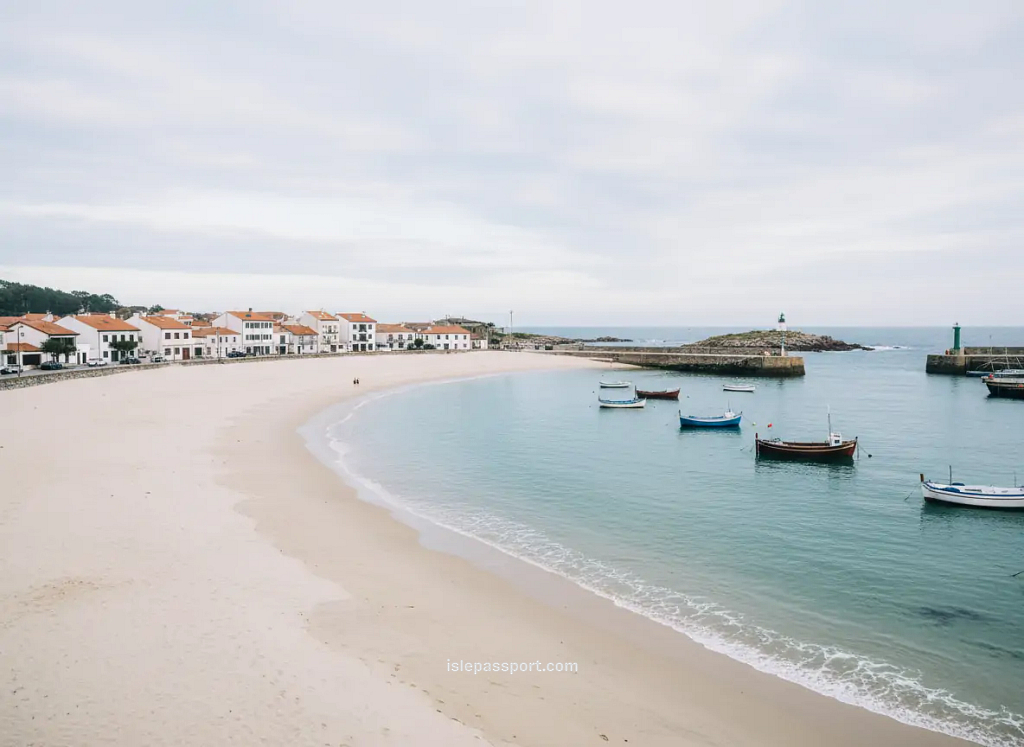 Wide sandy beach and small fishing harbor in Laxe on Galicia’s Costa da Morte