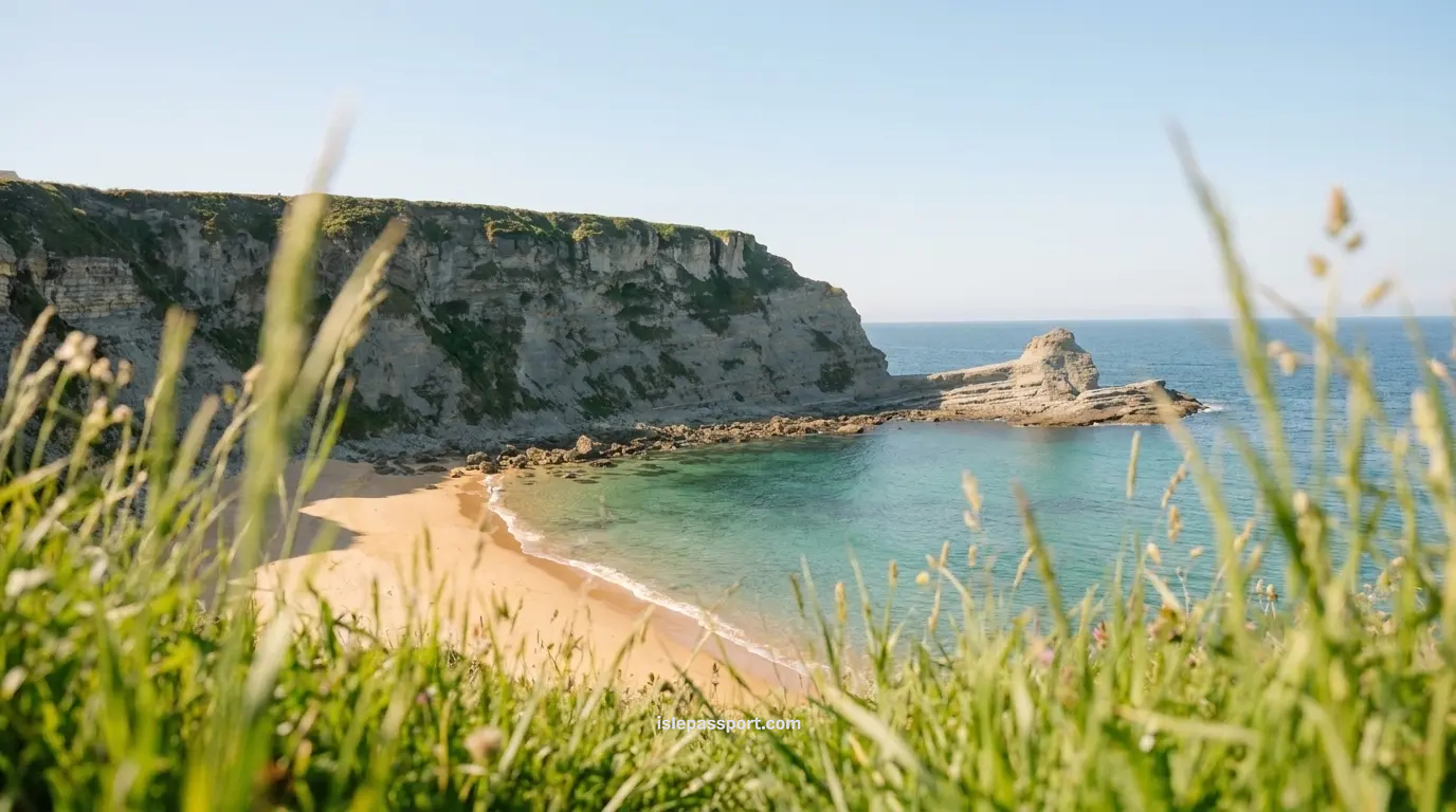 Clifftop view of Playa de Langre in Cantabria, featuring dramatic vertical cliffs and emerald green water, a prime example of the best beaches in Northern Spain.