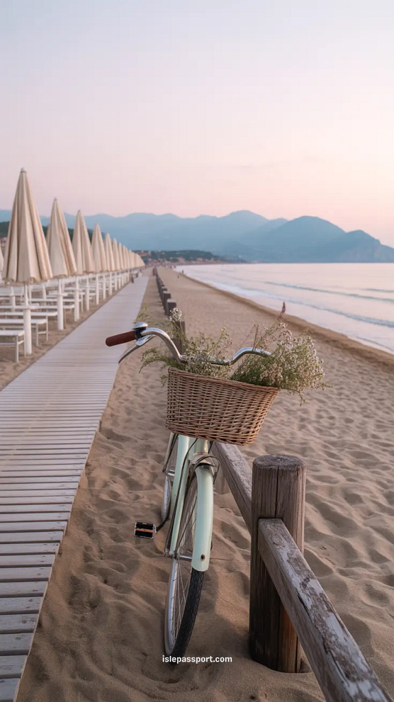 Marina di Pietrasanta beach with boardwalk, umbrellas, and mountain backdrop in soft morning light