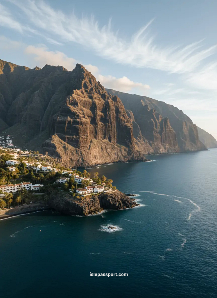 Los Gigantes cliffs in Tenerife with massive basalt walls rising above deep-blue Atlantic water and tropical vegetation