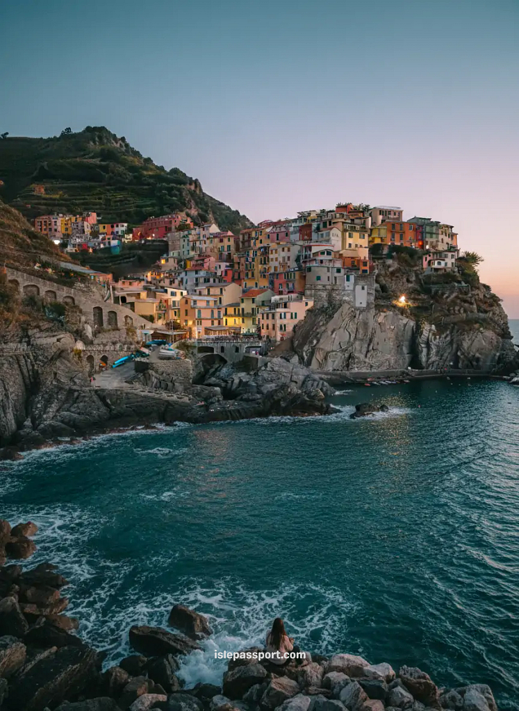 traveler watching sunset over manarola cinque terre