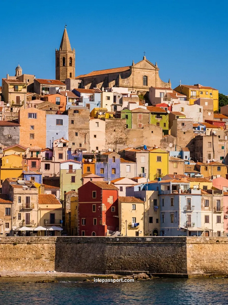 Colourful buildings and cathedral tower of Alghero old town rising above the sea walls and harbour in northwest Sardinia