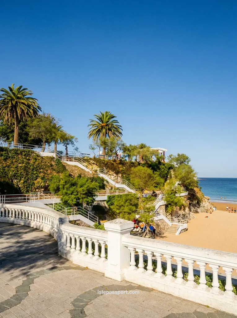 Elegant white balustrade promenade with palm trees and terraced steps overlooking El Sardinero beach in Santander, Cantabria, northern Spain