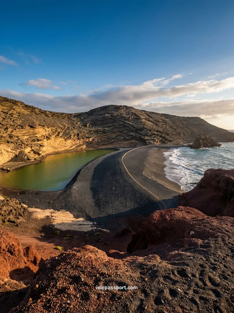 Green lagoon at El Golfo on Lanzarote's coast in winter, red volcanic rock and black sand at sunset
