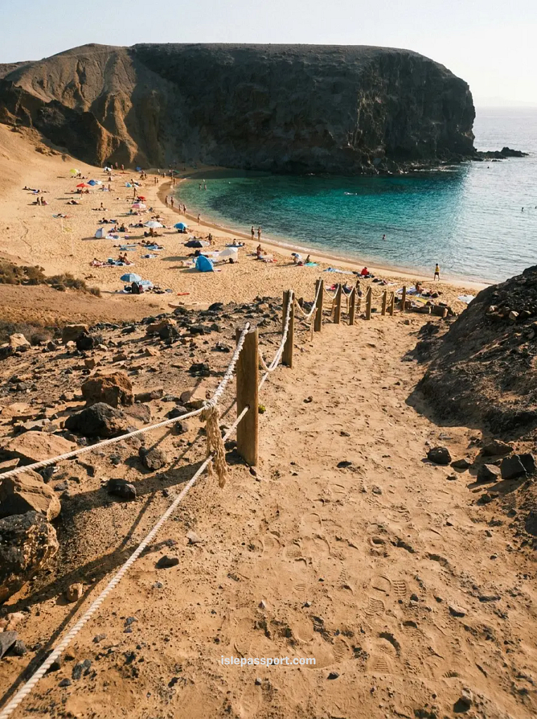 Papagayo beach coastline in Lanzarote in winter with golden late-afternoon light and clifftop village