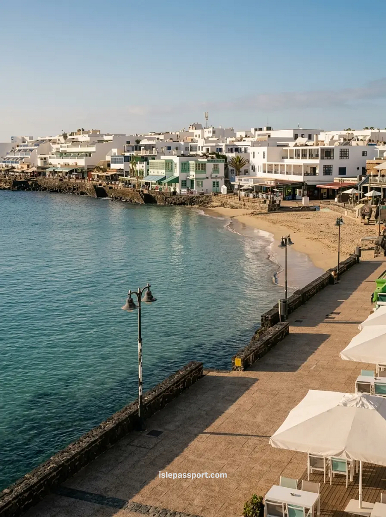 Playa Blanca town beach and seafront promenade with whitewashed buildings and cafés, Lanzarote