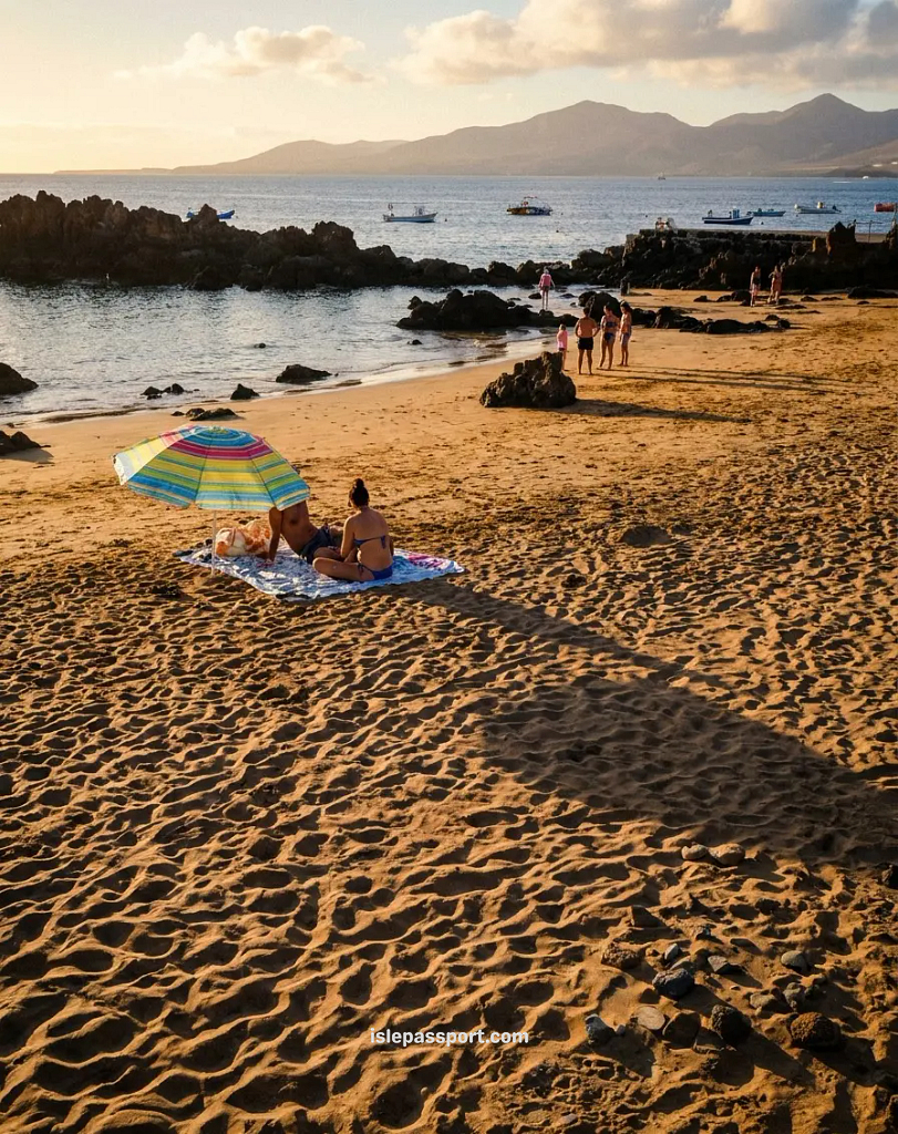 Puerto del Carmen beachfront in Lanzarote in winter at sunset with palm trees and long shadows